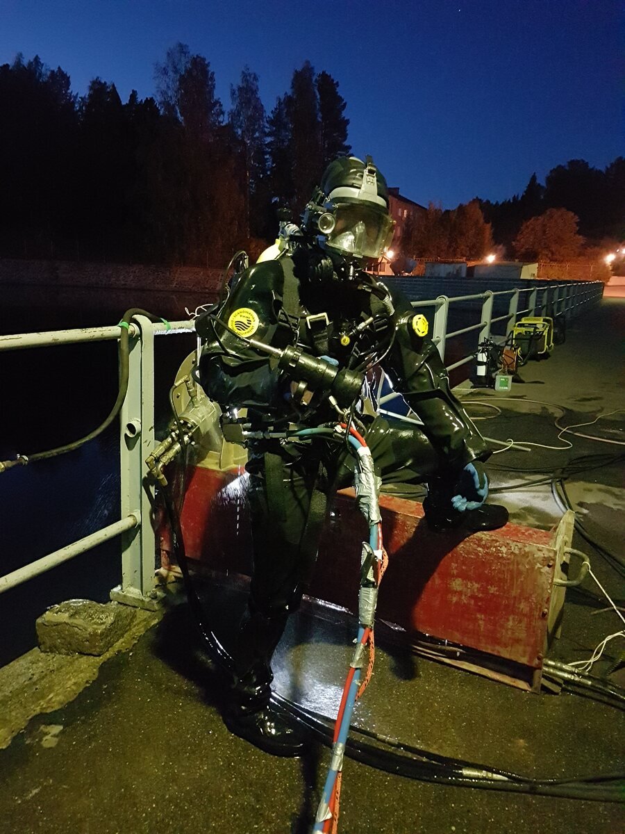 Qualified commercial diver supporting an underwater wire-sawing operation
